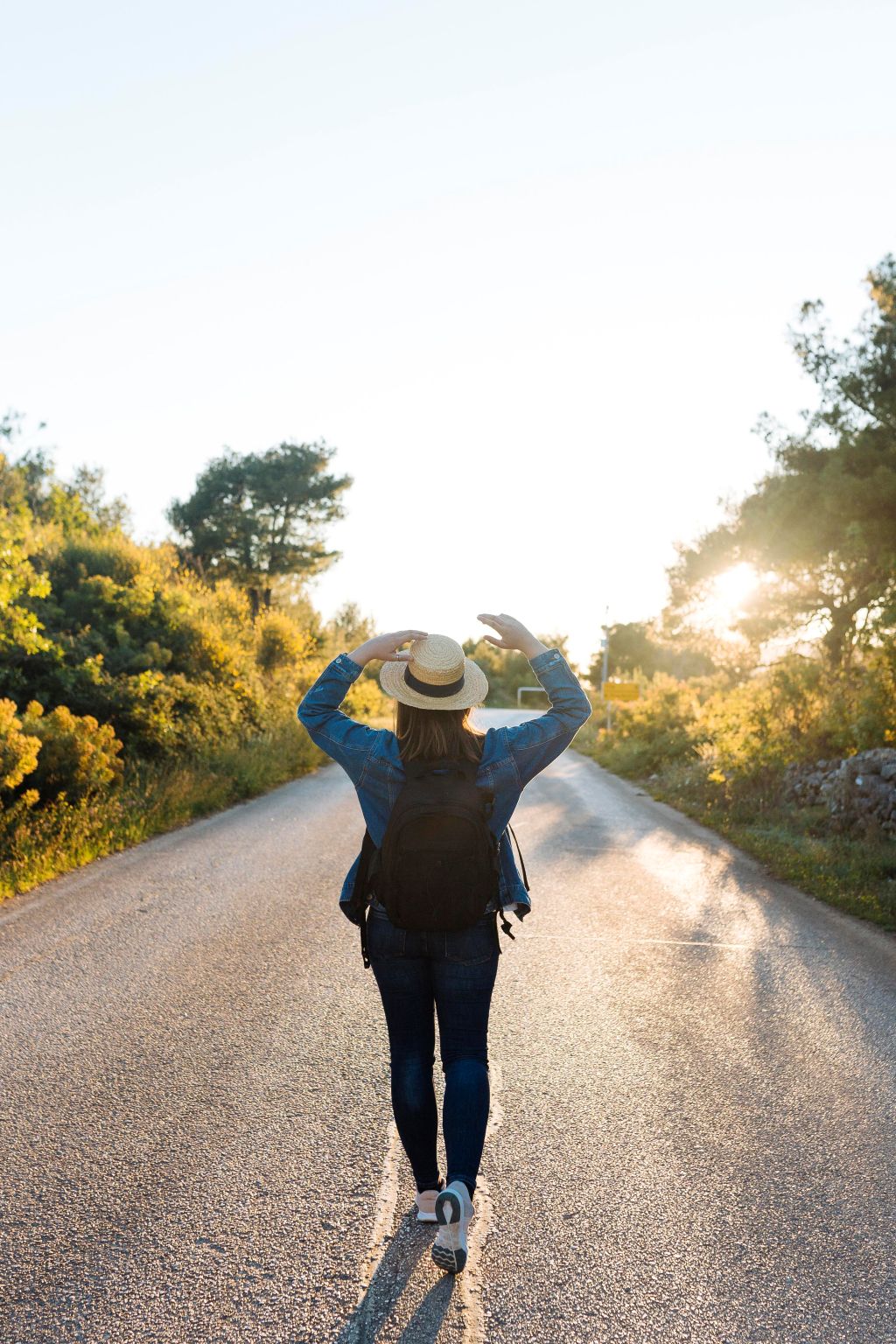 woman-posing-with-backpack-middle-road woman-posing-with-backpack-middle-road